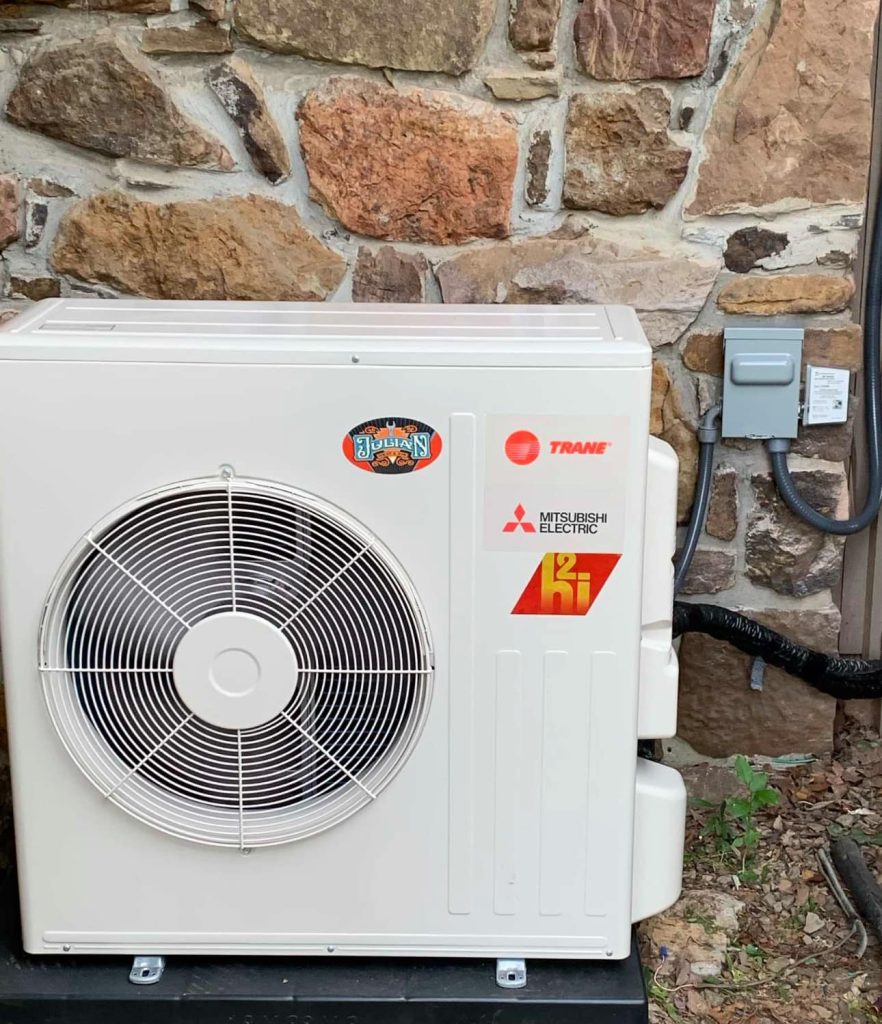 AC unit with trane, Mitsubishi electric and Julian Heat and Air stickers