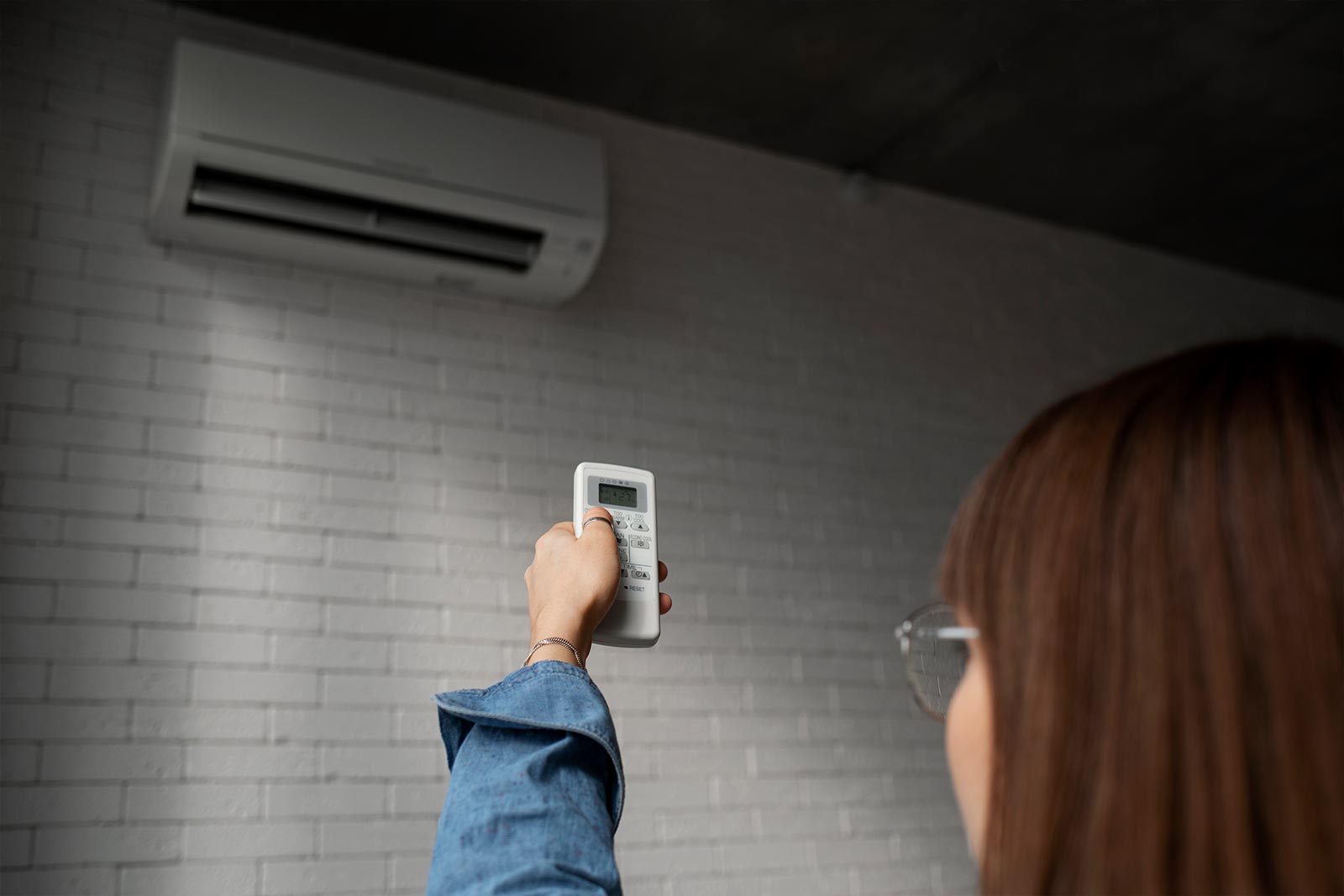 Girl adjusting AC temperature