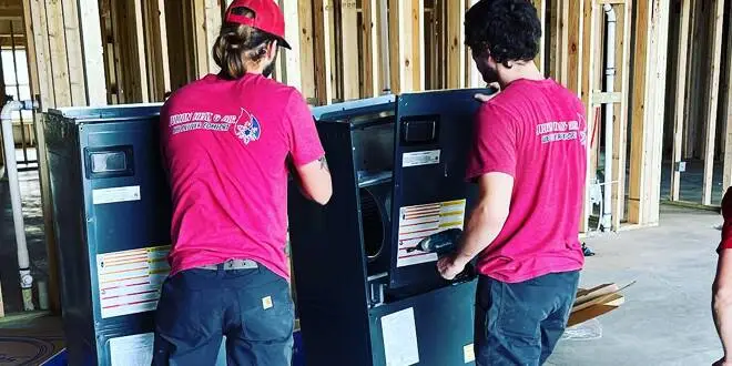 furnace maintenance, two technician working in a furnace unit