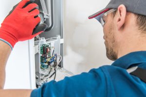 HVAC contractor inspecting a furnace system